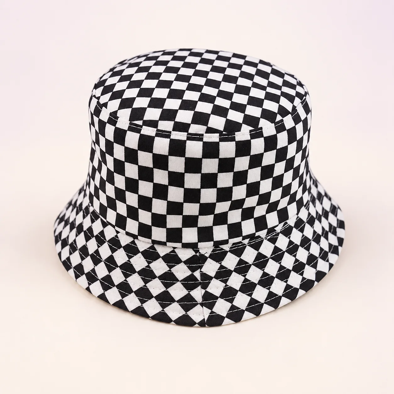 Black and white checkerboard bucket hat with a stitched brim