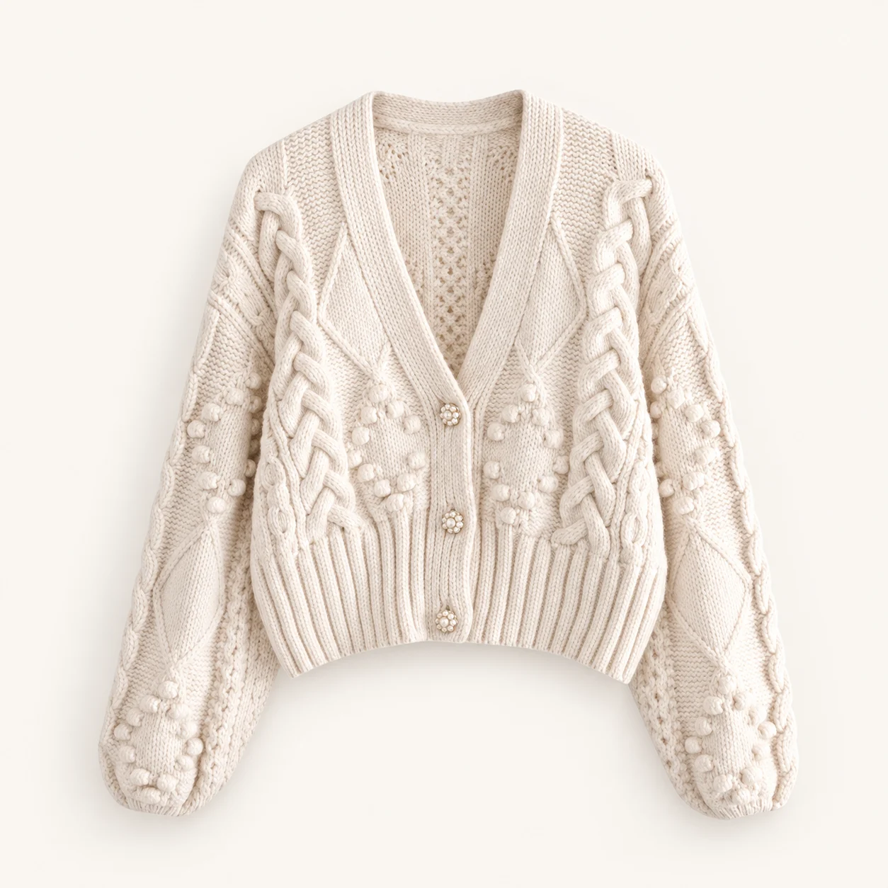 Ivory cropped V-neck cardigan with cable and bobble knit detailing and three decorative buttons