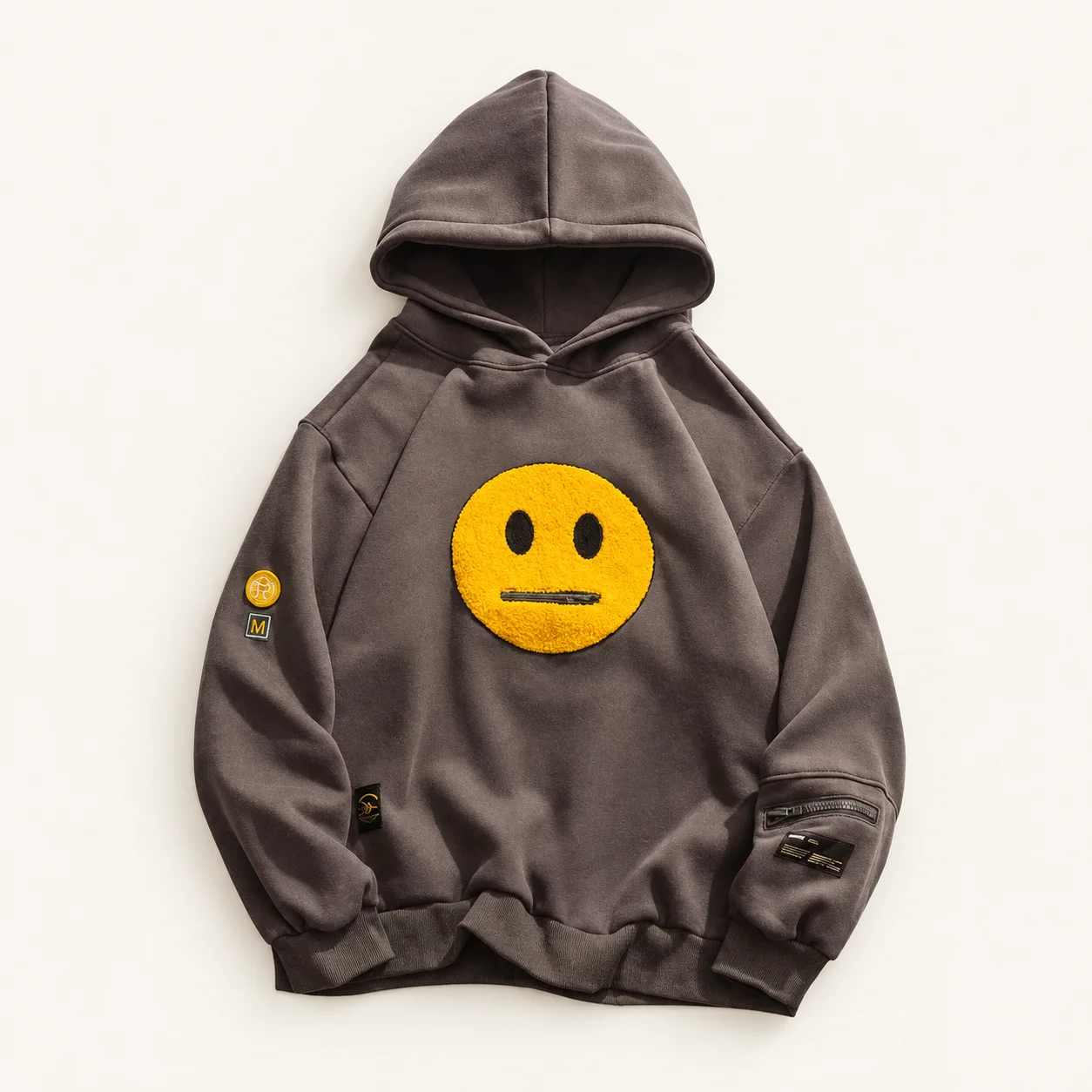 Charcoal Zipper Pocket Emoji Hoodie with yellow face patch and sleeve zipper pocket, front view